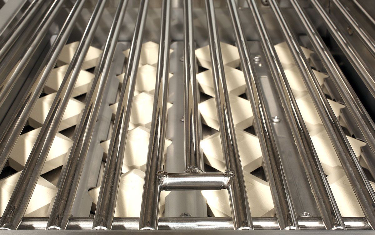 Angle view of deep grill rack with parallel bars and diamond-shaped inserts beneath